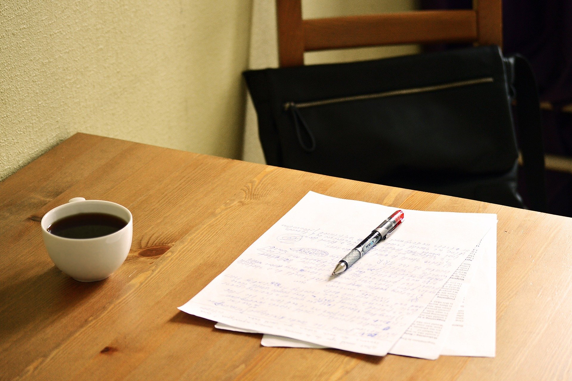 Desk with pen and paper placed on top